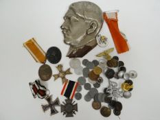 A quantity of German Third Reich medals and badges together with a metal decoration of Hitler in