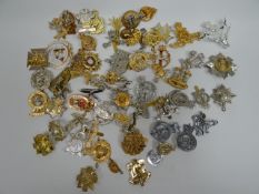 A quantity of mainly Staybright regimental cap badges