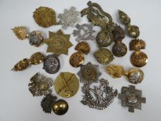 A quantity of assorted regimental cap badges, shoulder titles and collar badges