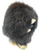 A Welsh Guards synthetic bearskin with yellow metal and leather chinstrap and wicker lining