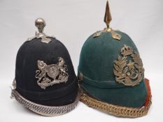 One blue cloth helmet and another green cloth helmet, both with metal plates and fittings