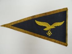 A German Nazi triangular car pennant with Luftwaffe eagle and swastika and gilt embroidered border