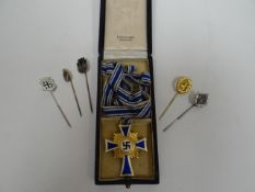 A Nazi German Mother's Cross in box together with five small pin badges