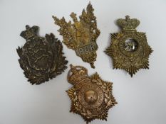 Four regimental helmet plates