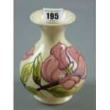 A Moorcroft Magnolia cream ground vase, impressed and painted marks to the base, 13 cms high