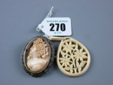 An oval floral ivory pendant and an oval lady cameo in a white metal frame