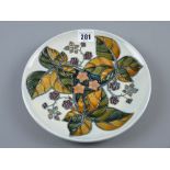 A Moorcroft Blackberry plate on a grey/blue ground, 22 cms diameter with underglazed blue