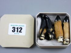 A pair of ivory mounted animal claws and animal horns