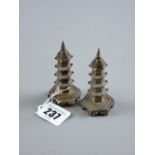 A pair of Oriental silver hexagonal based pepperettes in the form of pagoda towers, 1.9 ozs