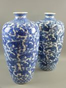 A large pair of Oriental export blue and white vases decorated with constant bands of carp and