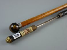 A malacca gentleman's cane with white metal crown shaped top holding a tiger's eye ball grip with