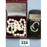 A natural pearl necklace of non-graduated pearls with a fine nine carat gold scrolled clasp with