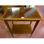 An Edwardian mahogany two tier rectangular side table with multi-wood crossbanded edging, line