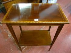 An Edwardian mahogany two tier rectangular side table with multi-wood crossbanded edging, line