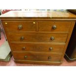 A Victorian mahogany chest of two short over three long drawers with rounded corners, cock beaded