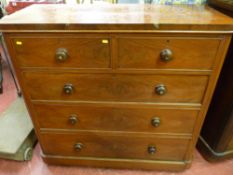 A Victorian mahogany chest of two short over three long drawers with rounded corners, cock beaded
