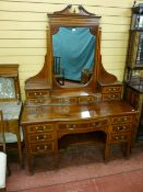 A top quality Edwardian inlaid mahogany dressing table, the mirror with broken swan neck pediment