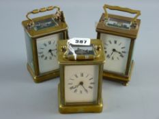 Three early 20th Century brass cased carriage clocks with bevelled glass panels, white dials and