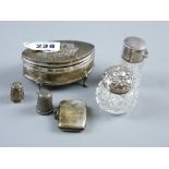 An oval silver ring box on four supports, the hinged lid having raised cherubic decoration and