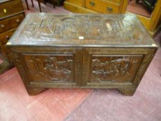 An Oriental carved camphorwood two door chest on step bracket feet, twin opening front doors