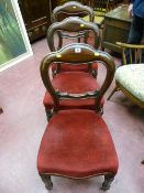 Three Victorian mahogany balloon back chairs with carved cross bar, turned reeded front supports and