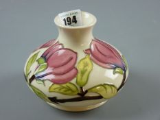 A Moorcroft Magnolia squat baluster base on a cream ground, impressed and painted marks to the base,
