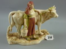 A Royal Dux figurine of a standing cow with maiden and pitcher standing alongside on a shaped oblong