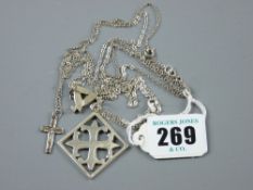 A white metal crucifix and chain, a small triangular silver pendant and chain and a square Celtic