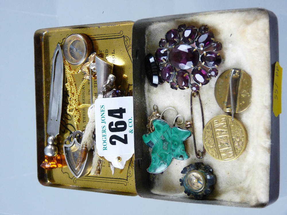 A silver claw brooch with thistle mounted precious stone, a silver menu holder with precious