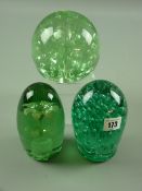 Three 19th Century green glass dump weights, one with internal floral inclusion, the remaining two