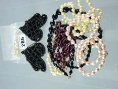 A buckle of tiny French jet beads, a twin strand bead necklace and various other pearl and black