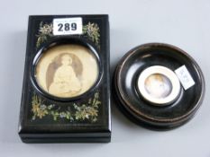 A floral decorated ebonized late Victorian family photograph card case with circular viewing