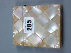 A mother of pearl card case with diamond shaped panels, silver mount to the lid and end hinge