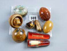 A parcel of five decorative olive wood and other eggs, a cased ivory silver and amber cigarette