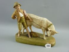 A Royal Dux figurine of a bull with its young handler on an oblong base, no. 1494, 27 cms long, 27
