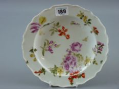 A circular cream ground Chelsea plate with floral decoration, anchor mark to the base, 21 cms