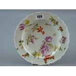 A circular cream ground Chelsea plate with floral decoration, anchor mark to the base, 21 cms