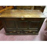 An 18th Century oak panel sided mule chest, polished three plank lift-up lid with iron lock and
