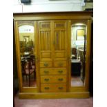 A good oak circa 1900 combination wardrobe, a stepped cornice with decorative frieze over twin