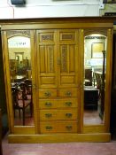 A good oak circa 1900 combination wardrobe, a stepped cornice with decorative frieze over twin