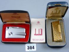 A mint and cased Dunhill Rollagas cigarette lighter, the case in yellow metal bark effect and a
