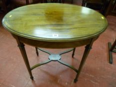 An oval top inlaid mahogany side table with crossbanded frieze on tapering supports with 'X' frame
