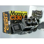 A Mamiya C330 Professional 6x6 twin lens Reflex camera, boxed with instructions and carrying strap