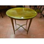 An Edwardian oval topped mahogany and crossbanded side table with boxwood strung slender tapering