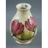A Moorcroft Magnolia cream ground bulbous vase, impressed marks and painted 'WM' to the base, 19 cms