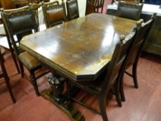 An oak draw leaf dining table and six chairs, carved edge table with cut-off corners and carved