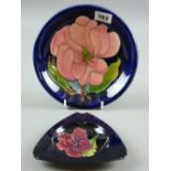 A Moorcroft Magnolia blue ground dish, 18.5 cms diameter, impressed marks and painted signature to