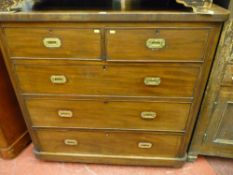 A Victorian mahogany chest of two short over three long drawers with rounded corners on bun feet,