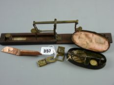 A mahogany cased set of sovereign and half sovereign scales and a tin enclosed traveller's scales