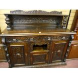 A late 19th Century carved oak sideboard with carved back and shelf with bulbous supports, twin